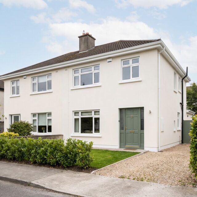 A house exterior freshly painted in warm white